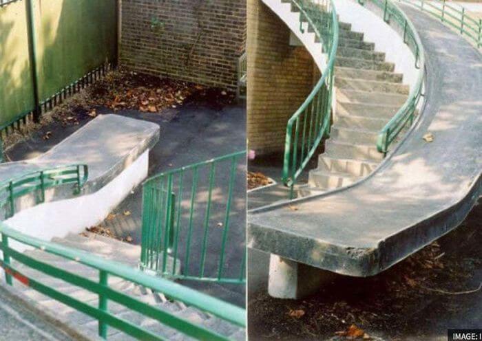 Steep winding accessibility ramp leading to a wall