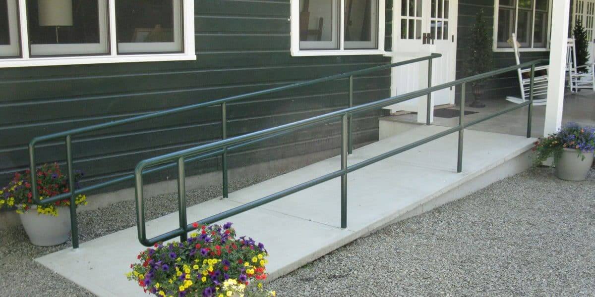 Well designed wheelchair ramp with supporting railings on either side