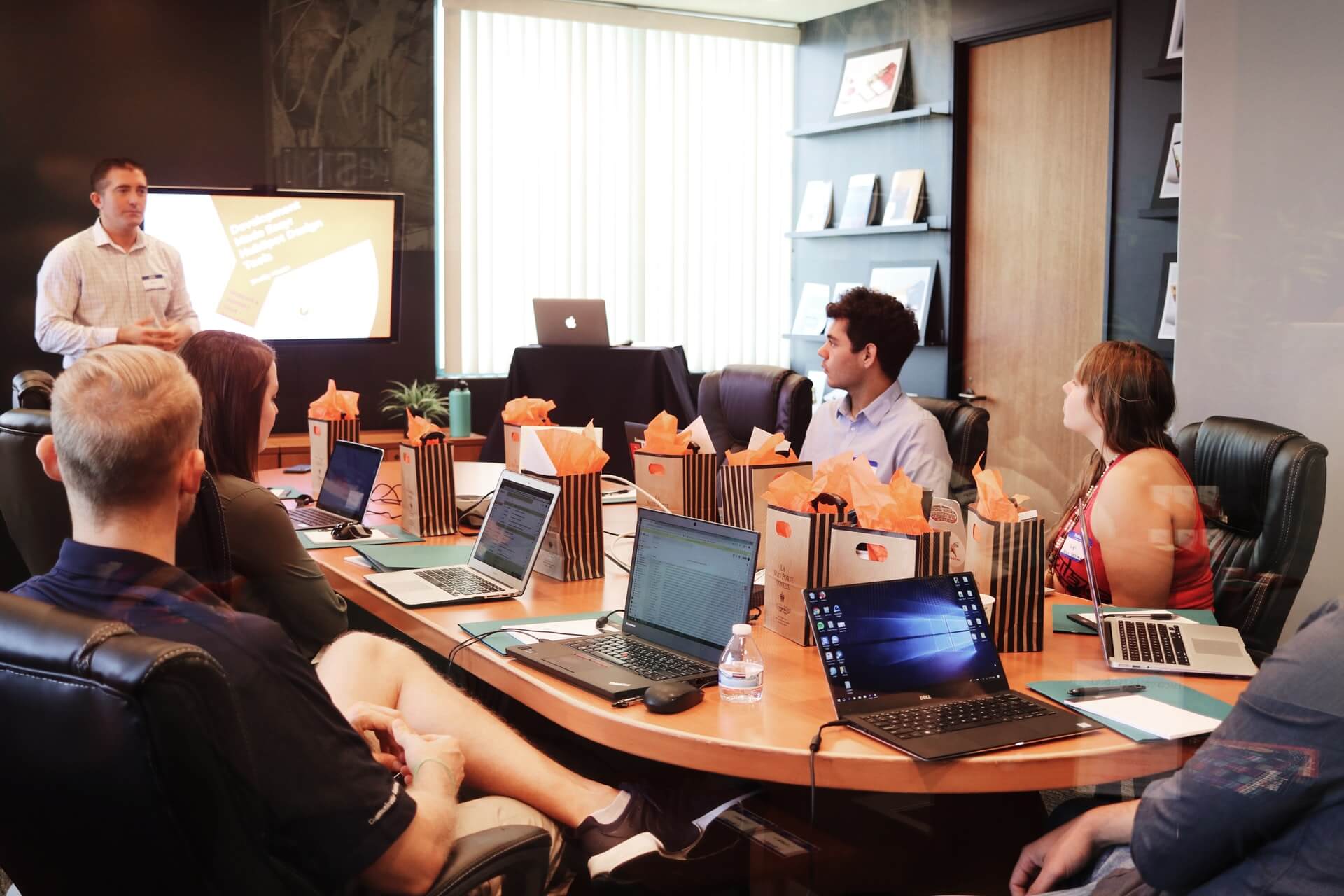 A man giving a presentation in a boardroom